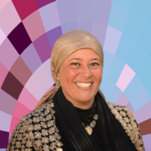 Headshot of Hanan Sabry, a smiling woman wearing a dark top, a gold jacket and headscarf, and a necklace and earrings, all on top of a MYFest background of colorful pink, purple and blue four-sided shapes spiraling out from the center.