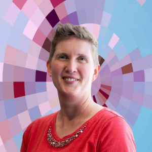 Headshot of Laura Dumin, a smiling white woman with short light hair wearing a red shirt and a necklace on top of a MYFest background of colorful pink, purple and blue four-sided shapes spiraling out from the center.
