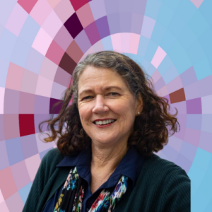 Headshot of Janet Small, a smiling woman with long brown hair wearing a dark blue top and a colorful scarf, on top of a MYFest background of colorful pink, purple and blue four-sided shapes spiraling out from the center.