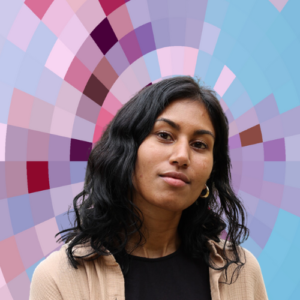 Headshot of Mishka Reddy, a smiling woman with long dark hair wearing a dark top and a light sweater, on top of a MYFest background of colorful pink, purple and blue four-sided shapes spiraling out from the center.